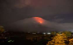 Orange glow seen at the cloud-shrouded crater of Mayon volcano at Legazpi city, Albay province, about 340 kilometers (210 miles) southeast of Manila, Philippines.