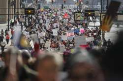 Protestors participate in a Women’s March highlighting demands for equal rights and equality for women, in Cincinnati. 