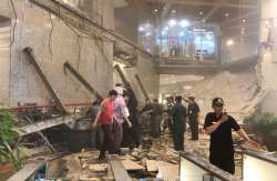 Indonesian security stand near the ruin of a structure inside the Jakarta Stock Exchange tower. 