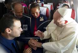 Pope Francis marries flight attendants Carlos Ciuffardi, left, and Paola Podest, center, during a flight from Santiago, Chile on Thursday, January 18, 2018. 