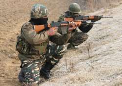 Soldiers take position during an encounter in Pulwama district's Lethpora area