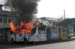 A bus set on fire by a group of people who went on a rampage after the cremation of a young man killed on Friday during the Tiranga bike rally, in Kasganj on Saturday. 