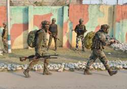 Security personnel take positions during a militants attack at Sunjwan Army camp in Jammu on Saturday