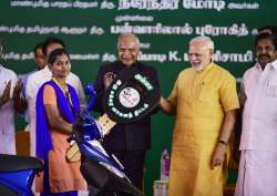 PM Modi launching TN govt's Amma scooter scheme for working women by handing over a vehicle to a beneficiary in Chennai on Saturday.