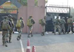 Security personnel take positions during a militants attack at Sunjwan Army camp in Jammu on Saturday