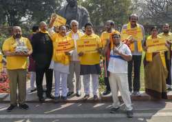 TDP MP & Former Union Civil Aviation Minister Ashok Gajapathi Raju with Party MP's protest in front of Mahatma Gandhi's statue at Parliament House demanding special status for Andhra Pradesh during the second phase of the budget session in New Delhi on Friday.