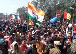 Congress workers wait outside a polling booth as counting of votes for Meghalaya assembly election is underway, in Shillong