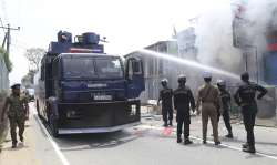 Ambatenna Sri Lankan police officers attempt to douse burning shops in Ambatenna, in central Sri Lanka, Wednesday.