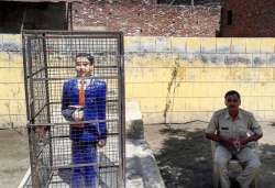 Badaun: A statue of Dr Bhimrao Ambedkar locked in an iron cage, in Badaun on Thursday. A staue of the leader recently raised controversy after it was painted in saffron. 