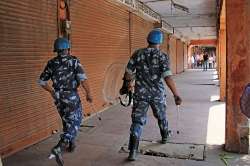 Jaipur: Rapid Action Force personnel walk past closed shops at wall city during 'Bharat bandh' over Scheduled Castes/Scheduled Tribes reservation issue, in Jaipur on Tuesday