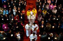  
Chinese Bishop Joseph Li Shan, center, walks down the aisle during a Holy Saturday Mass on the evening before Easter at the Cathedral of the Immaculate Conception, a government-sanctioned Catholic church in Beijing.