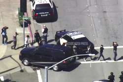 This image taken from video from KGO-TV shows people walk away from the YouTube headquarters area after being searched as police respond to reports of a shooting at the headquarters in San Bruno, California.