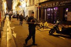 A police officer cordons off the area after a knife attack in central Paris, Saturday May 12, 2018. 