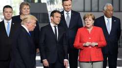 This file photo taken on May 25, 2017 shows French President Emmanuel Macron (2nd L) and German Chancellor Angela Merkel (R) speaking as US President Donald Trump (front L) arrives for a family picture during the NATO (North Atlantic Treaty Organization) summit at the NATO headquarters, in Brussels.