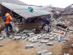 Villagers clear debris caused by an earthquake at Sajang village, Sembalun, East Lombok, Indonesia, Monday, July 30, 2018. 