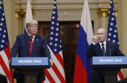 US President Donald Trump, left, listens to Russian President Vladimir Putin during a press conference after their meeting at the Presidential Palace in Helsinki, Finland