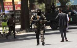 Security personnel patrol near a park where a would-be attacker was killed in Kabul, Afghanistan