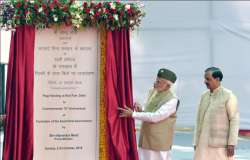 Prime Minister Narendra Modi unveils a plaque as Minister of State (Independent Charge) for Culture and Tourism Mahesh Sharma looks on, to commemorate the flag-hoisting event to mark the 75th anniversary of the 'Azad Hind government' headed by Subhas Chandra Bose, at Red Fort in New Delhi, Sunday, Oct 21, 2018