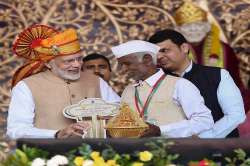 Prime Minister Narendra Modi hands over key of a house to a beneficiary of Pradhan Mantri Awas Yojana- Gramin (PMAY-G) at Shirdi, Maharashtra.