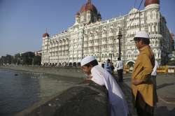 Two boys stand outside the iconic Taj Mahal Palace hotel, the epicenter of the 2008 terror attacks that killed 166 people in Mumbai, India. Thirty-one people died inside the hotel, including staff trying to guide the guests to safety. Visceral images of smoke leaping out of the city landmark have come to define the 60-hour siege.
 