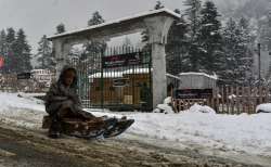 A child enjoy sledging on a road in Srinagar