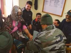 CRPF personnel providing medical attention to passengers stranded due to heavy snowfall on Jammu-Sri