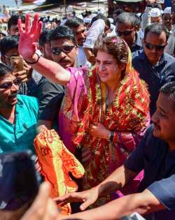 Congress General Secretary UP-East Priyanka Gandhi Vadra waves as she arrives at Dashashwamedh Ghat, in Varanasi