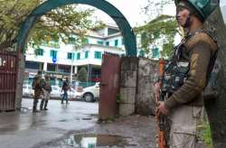 A security personnel stands guard outside an EVM distribution centre ahead of the second phase of Lo