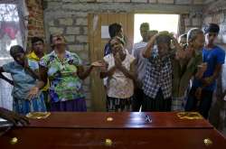 Relatives weep near the coffin with the remains of 12-year Sneha Savindi, who was a victim of Easter Sunday bombing at St. Sebastian Church.
 