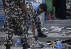 Nepalese army personnel examine the site of an explosion in Kathmandu.