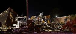 Emergency workers search through debris from a mobile home park, Sunday, May 26, 2019, in El Reno, Ok., following a likely tornado touchdown late Saturday night.
 