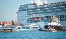 Video on social media showed the huge cruise ship heading for the dock, shoving the smaller boat out of the way, and causing onlookers on land to flee.