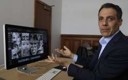 In this Monday, July 1, 2019, photo Hany Farid, a digital forensics expert at the University of California at Berkeley, gestures as he views video clips in his office in Berkeley, Calif