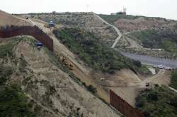 Construction crews replace a section of the primary wall separating San Diego, above right, and Tijuana, Mexico, below left, seen from Tijuana, Mexico. Defense Secretary Mark Esper has approved the use of $3.6 billion in funding from military construction projects to build 175 miles of President Donald Trump’s wall along the Mexican border.?