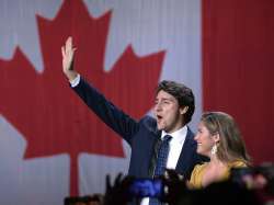 Liberal leader Justin Trudeau and wife Sophie Gregoire Trudeau wave as they go on stage at Liberal e