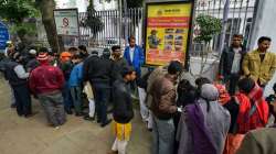 Family members of arrested people wait outside Daryaganj police station