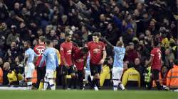 Players react to items thrown by Manchester City fans during the English Premier League soccer match between Manchester City and Manchester United at Etihad stadium 