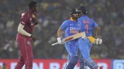 India's captain Virat Kohli , left, K L Rahul run between the wickets during the third and final one-day international cricket match of the series between India and West Indies in Cuttack