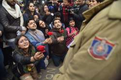 Protestors offering roses to security personnel 