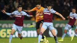 Wolverhampton Wanderers's Raul Jimenez, centre, challenges with West Ham United's Declan Rice, right, and Aaron Cresswell during their English Premier League soccer match