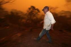 Man burned as huge wildfire forms during Australia crisis