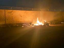 This photo released by the Iraqi Prime Minister Press Office shows a burning vehicle at the Baghdad 