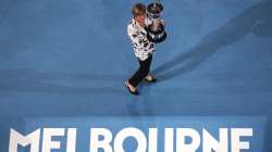 Former Australian Open champion Margaret Court holds up the women's Australian Open trophy, the Daphne Ackhurst Memorial Cup, as her 50th anniversary of her Grand Slam is celebrated at the Australian Open tennis championship in Melbourne