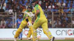 Australia's captain Aaron Finch, right, runs between the wicket with David Warner during the first one-day international cricket match between India and Australia in Mumbai