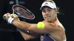 Germany's Angelique Kerber makes a backhand return to Italy's Elisabetta Cocciaretto during their first round singles match at the Australian Open tennis championship in Melbourne