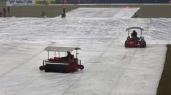 Ground staff work to dry the pitch and field following a light rain at Gaddafi stadium, in Lahore, Pakistan, Monday, Jan. 27, 2020. Pakistan and Bangladesh are scheduled to play the last T20 which is delayed due to rain in Lahore