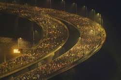 Maharashtra Cabinet on Wednesday approved its 'Mumbai 24 hours' policy allowing malls, multiplexes and shops to remain open round-the-clock in the city from January 27.  Photo shows runners compete along the Bandra-Worli sea link over the Arabian Sea during the Mumbai Marathon in Mumbai, India, Sunday, Jan. 19, 2020. Thousands of the city's residents alongside athletes took part in the marathon. (AP Photo/Rafiq Maqbool)