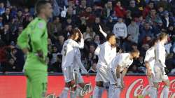 Real Madrid's Raphael Varane, rear left, celebrates after scoring his side's second goal during a Spanish La Liga soccer match between Getafe and Real Madrid at the Coliseum Alfonso Perez stadium