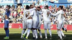 Real Madrid's Raphael Varane, third left, celebrates after scoring his side's opening goal during a Spanish La Liga soccer match between Getafe and Real Madrid.