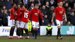 Manchester United's Anthony Martial, left, celebrates scoring his side's fifth goal of the game against Tranmere, with teammates during their English FA Cup fourth round soccer match at Prenton Park in Birkenhead